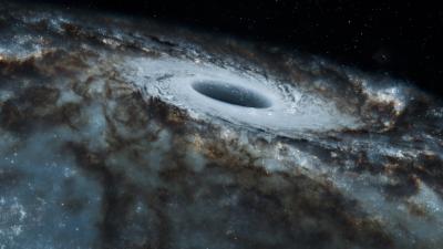 Black and white view of a black hole surrounded by swirling stars in a spiral galaxy